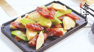 熱油下鍋，依次下金字香腸、萵筍、冬筍，均勻翻炒。