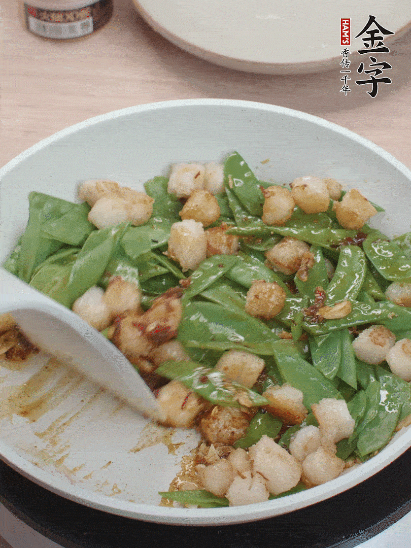 下甜豆莢、鮮貝輕輕翻炒均勻。